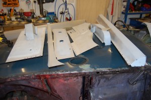 All panels primed and plug welding holes prepared. Red tinge is reflected infra red heater.