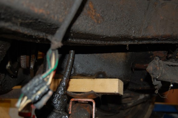 Support rear of engine.