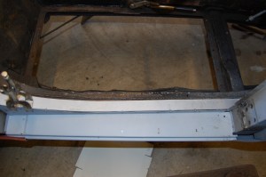 This shows the fitting of the outer sill and attachment of chassis rail finishing strip, screwed up ready for welding top and bottom and pop-riveting the end flanges to the door pillars as per original spec. Outer sill inner surface by this stage has been zinc primed and two coats of black Hammerite applied. The hole in the right hand corner of the sill panel is the drain hole that will sit under the door draught seal rubber edge and acts to drain any trapped water. A corresponding hole in the top surface of the inner sill allows the water to drain into the sill void and out through gaps in the lower edge. Any excess moisture will evaporate in the void of the inner sill, the ends of which are not sealed. Seems counter intuitive, but apparently works - careful rust inhibiting preperation is required to the inside surfaces of the inner sill, to ensure longevity - not of concern to the Abingdon factory in 1959!