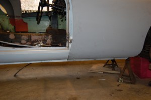 Having completed the welding and grinding flat, another trial fit - for some reason, nothing fitted and several frustrating hours were spent finding the reason. Joined by fellow MGA owner Ray Hadaway, we took a fresh look at all aspects, particularly the fit of the front wing bottom edge, which was too low to bolt up to the inner panel. Following some minor assistance from a jack and wood block, it eased into shape. Holes were drilled to match up with the captive nuts on the inner panel and it bolted up well as can be seen in the photo.