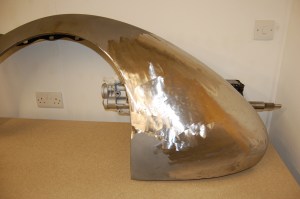 The nearside door and rear wing had suffered damage at some point before my ownership, which was revealed when they were stripped. This is the rear wing after blasting and hand beating, followed by lead loading.