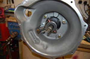 Fitting the new Hi-gear bell housing to the 5 -speed gearbox. The original clutch fork had worn badly at the fulcrum bolt point and a replacement was sourced. New thrust bearing.