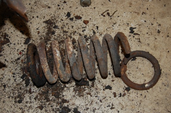 Broken front spring. The front shock absorbers were shot when the car was in use as I couldn't afford to replace them, I topped them up with engine oil...not ideal. The effect of the lack of damping must have caused the springs to fracture.