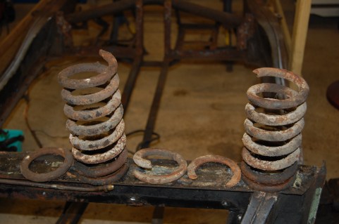 Both springs had broken at the base end, the left hand in two places. I had no idea before stripping, as the car maintained its ride height.