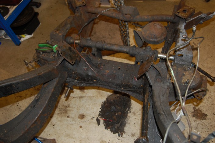 Front suspension stripped down easily thanks to the thick covering of oil and grease, several pounds of which is on the floor. Chassis required fully degreasing before going for shot blasting. Also this is a useful shot of where the front brake pipes run.