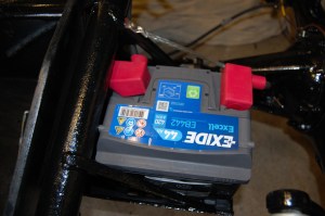 I happened to have an old dead battery from a Nissan Micra which I tried in the adjusted cradle and found that it was a perfect fit. I tracked down a new one for £33 ($48) and it fits well with even a lug that butts up against the chassis tube.